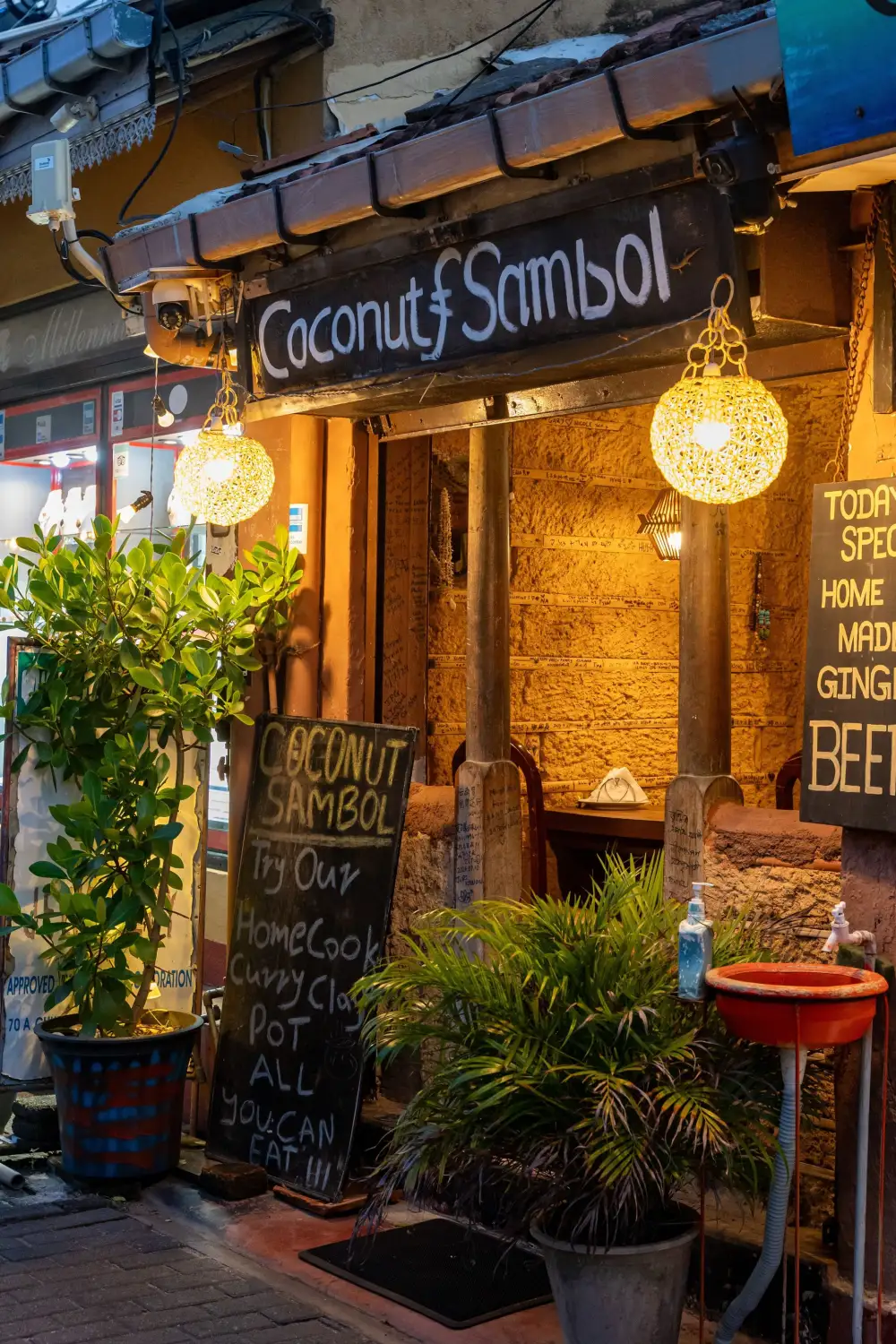 A lantern-lit shopfront on a street at night