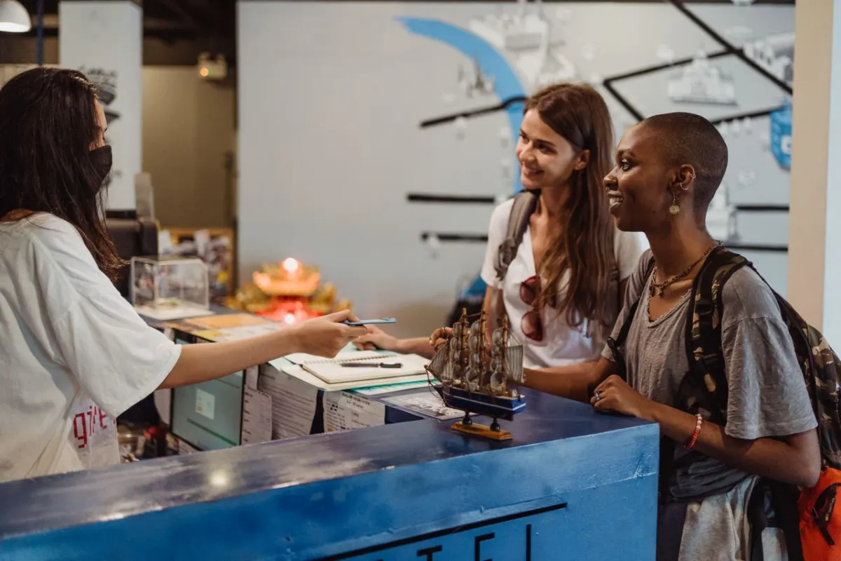Travellers checking in at a hostel counter
